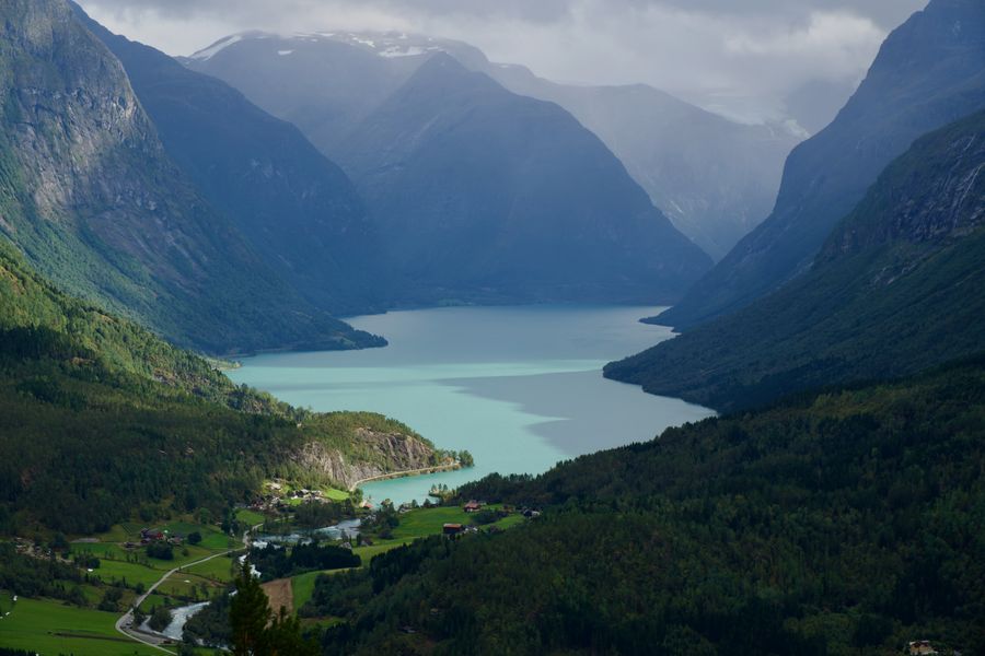 A turquoise lake winding through a deep green valley