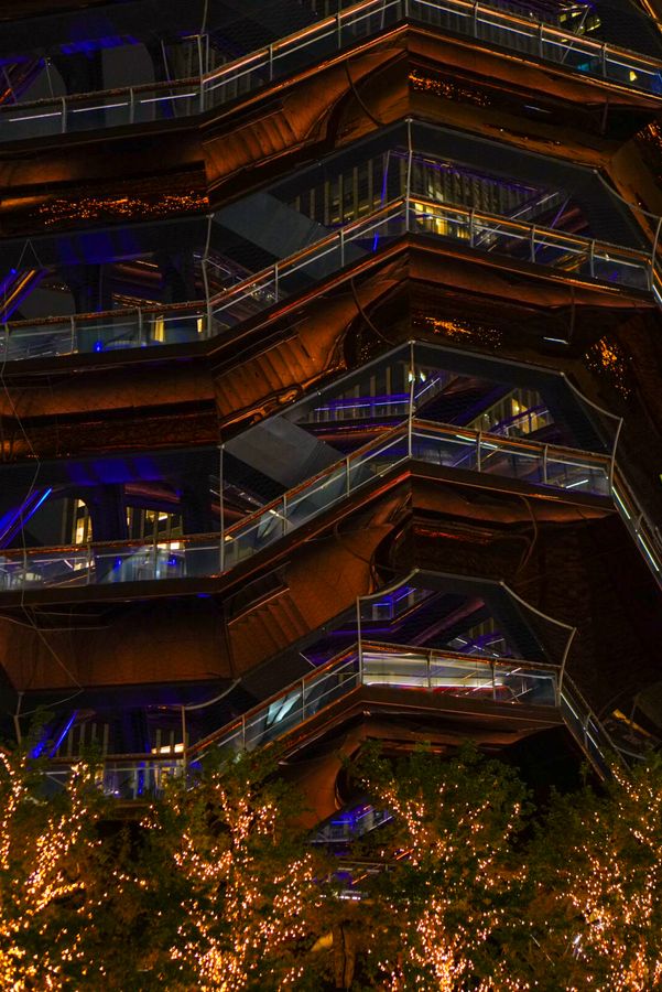 A honeycomb of copper staircases lit at night