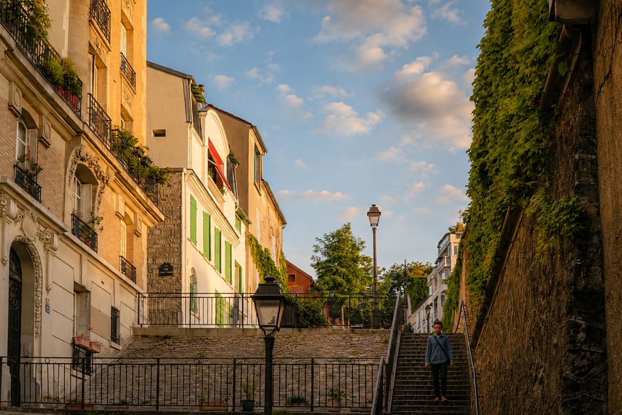 Stone stairs climbing a quiet hillside street in late sun