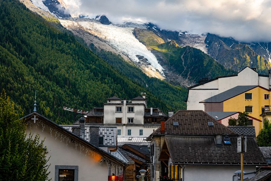A glacier above the rooftops of a mountain village
