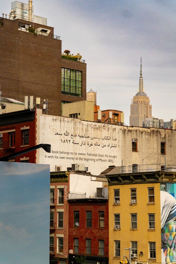 Painted old walls and colourful buildings with the Empire State Building behind